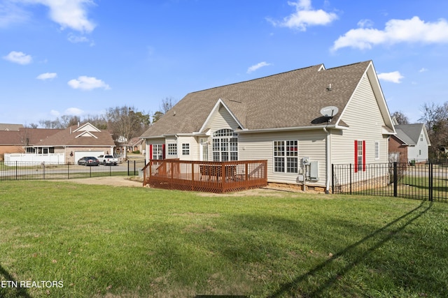 back of house featuring a deck and a yard