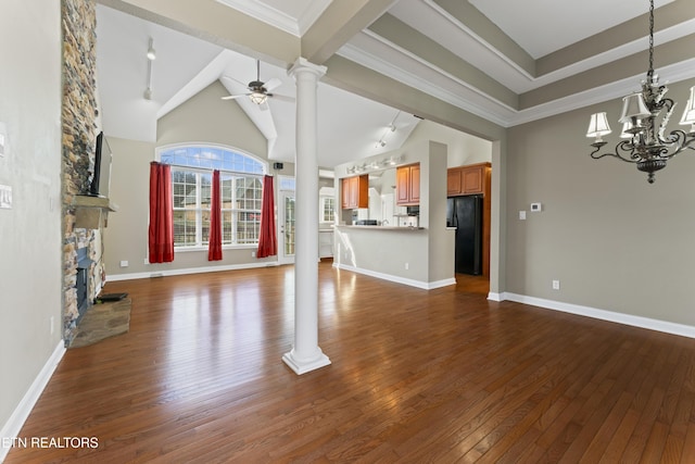 unfurnished living room featuring decorative columns, dark hardwood / wood-style flooring, a fireplace, ceiling fan with notable chandelier, and beamed ceiling