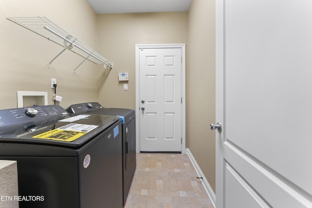 clothes washing area featuring washer and clothes dryer