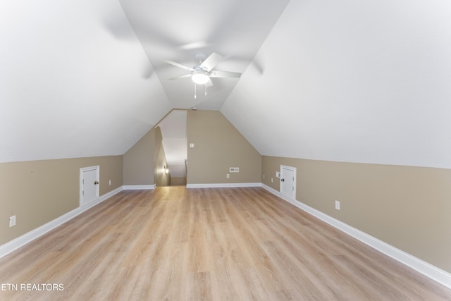 additional living space featuring ceiling fan, light wood-type flooring, and vaulted ceiling