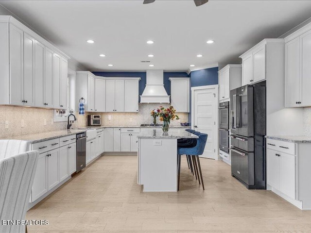 318 Buckhorn Way, Loudon, TN 37774 - kitchen featuring appliances with stainless steel finishes, custom range hood, recessed lighting, backsplash, and a center island