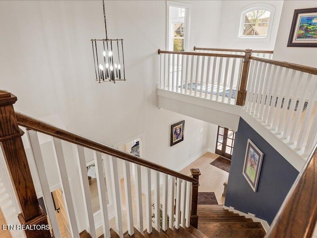 318 Buckhorn Way, Loudon, TN 37774 - stairway featuring a chandelier, a towering ceiling, and baseboards
