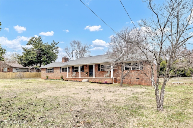 ranch-style house with brick siding, a front lawn, fence, and covered porch