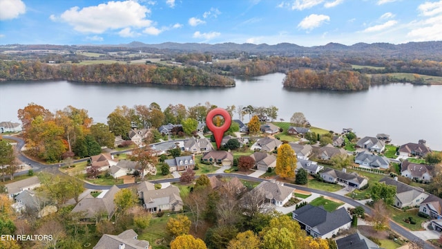 birds eye view of property featuring a water and mountain view