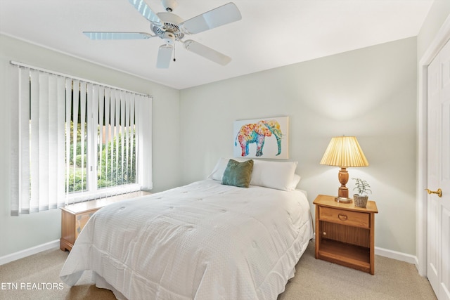 bedroom with light carpet and ceiling fan