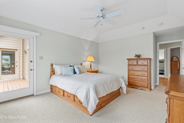 carpeted bedroom with access to exterior, ceiling fan, and vaulted ceiling