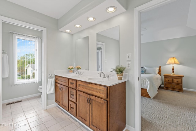 bathroom featuring vanity, toilet, and tile patterned flooring