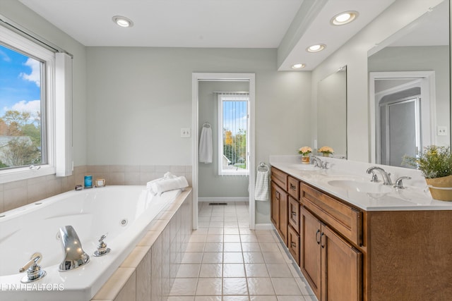 bathroom with tile patterned flooring, vanity, shower with separate bathtub, and a wealth of natural light