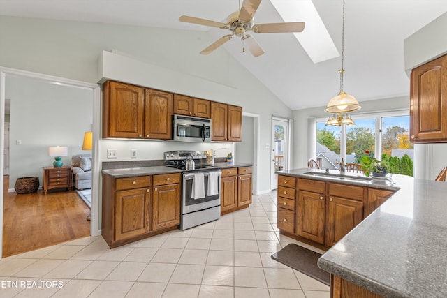 kitchen featuring ceiling fan, light tile patterned floors, pendant lighting, and appliances with stainless steel finishes