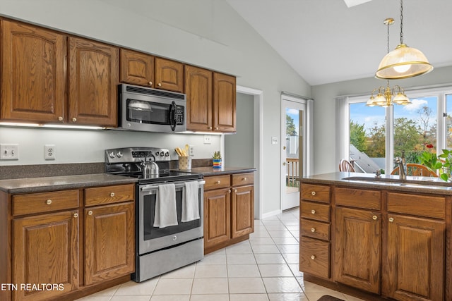 kitchen featuring a wealth of natural light, stainless steel appliances, pendant lighting, a notable chandelier, and lofted ceiling