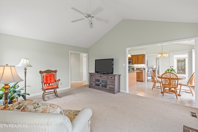 living room with ceiling fan with notable chandelier, light colored carpet, and high vaulted ceiling