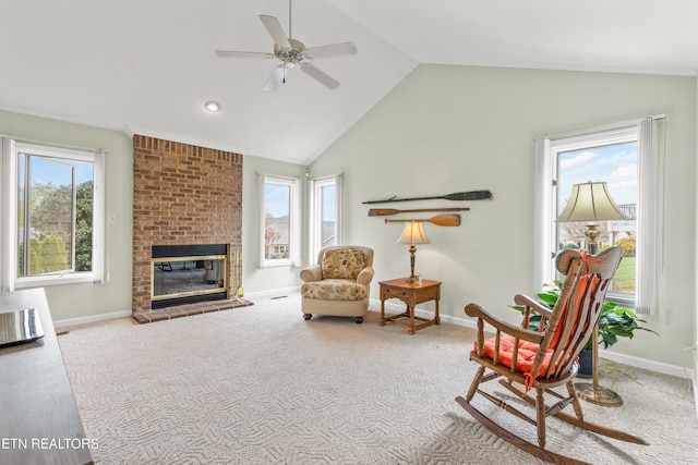 sitting room featuring light carpet, a brick fireplace, vaulted ceiling, and ceiling fan