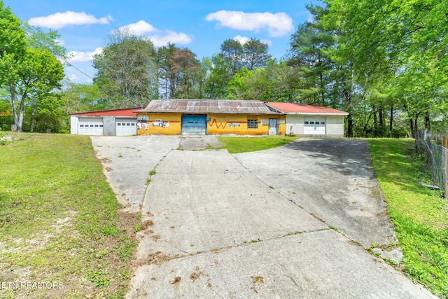 ranch-style home with a garage and a front yard