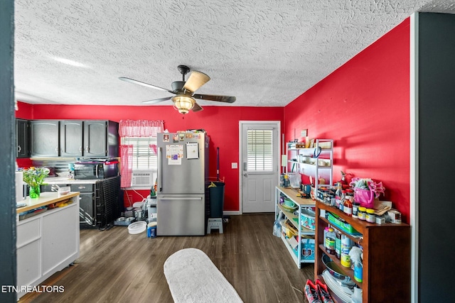 kitchen featuring ceiling fan, dark hardwood / wood-style flooring, plenty of natural light, and stainless steel fridge