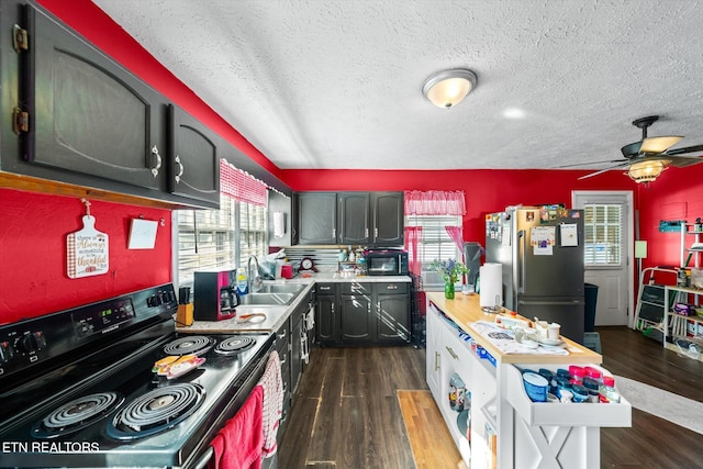 kitchen with dark hardwood / wood-style floors, sink, black appliances, a textured ceiling, and ceiling fan