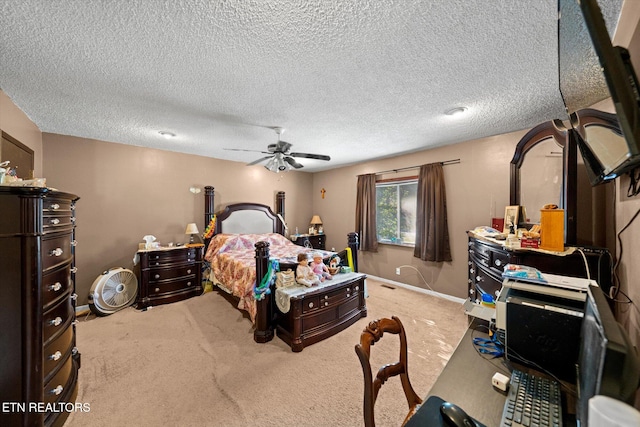 carpeted bedroom featuring a textured ceiling and ceiling fan