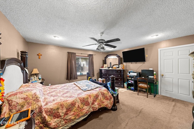 carpeted bedroom with a textured ceiling and ceiling fan