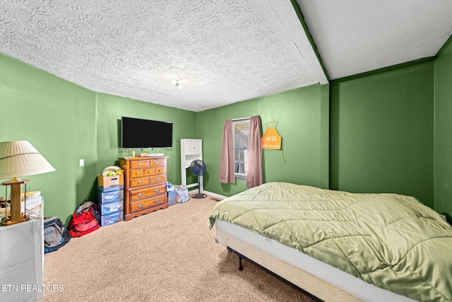 bedroom featuring a textured ceiling and carpet flooring