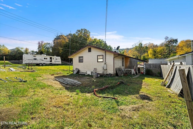 back of property featuring a yard