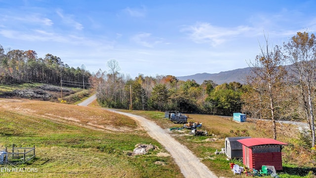 exterior space featuring a mountain view and a storage shed