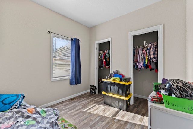 bedroom with hardwood / wood-style floors and a closet