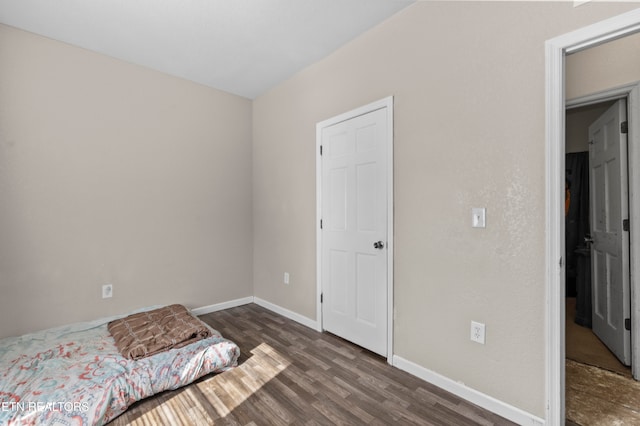 bedroom featuring dark wood-type flooring