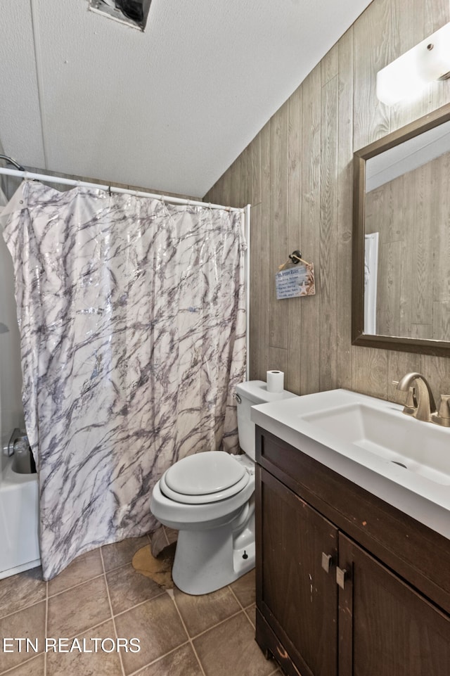 full bathroom featuring vanity, wood walls, tile patterned flooring, toilet, and shower / bath combo with shower curtain