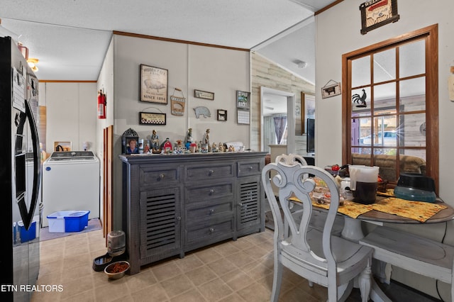 office space with washer / clothes dryer, lofted ceiling, a textured ceiling, and ornamental molding