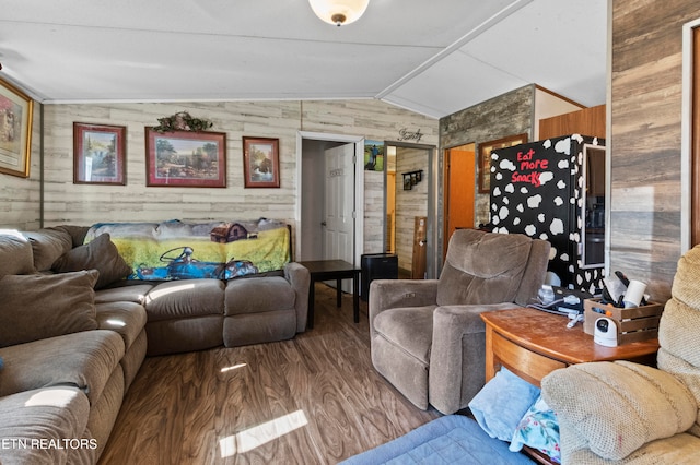 living room featuring hardwood / wood-style flooring, vaulted ceiling, and wooden walls