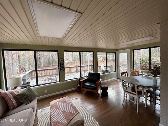 sunroom featuring wooden ceiling, vaulted ceiling, and a wealth of natural light