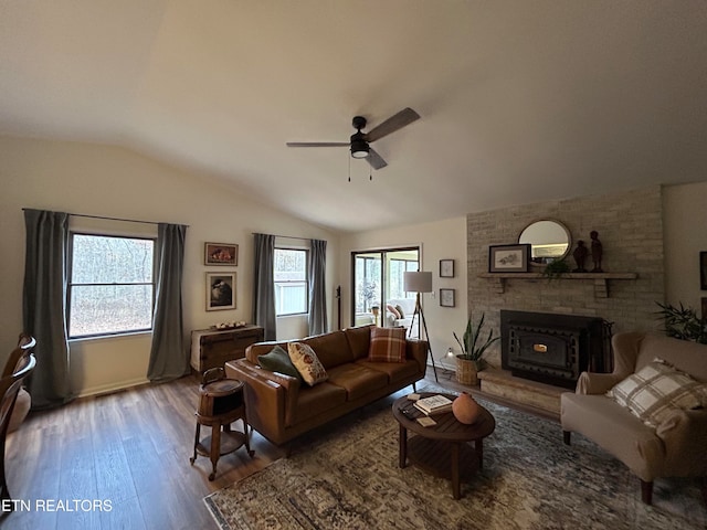 living room with hardwood / wood-style flooring, ceiling fan, and vaulted ceiling