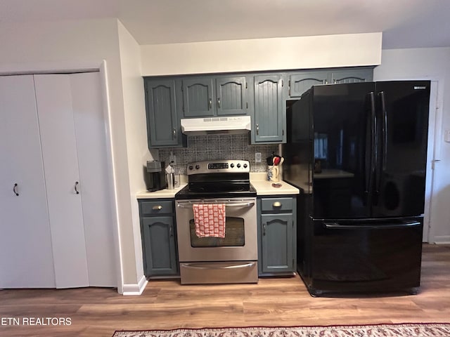 kitchen featuring decorative backsplash, black refrigerator, light hardwood / wood-style flooring, stainless steel electric range, and gray cabinets