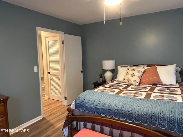 bedroom with a closet and hardwood / wood-style floors