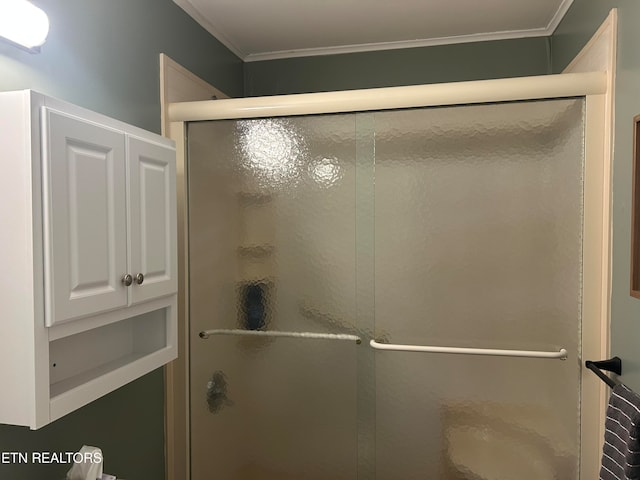 bathroom with crown molding and an enclosed shower