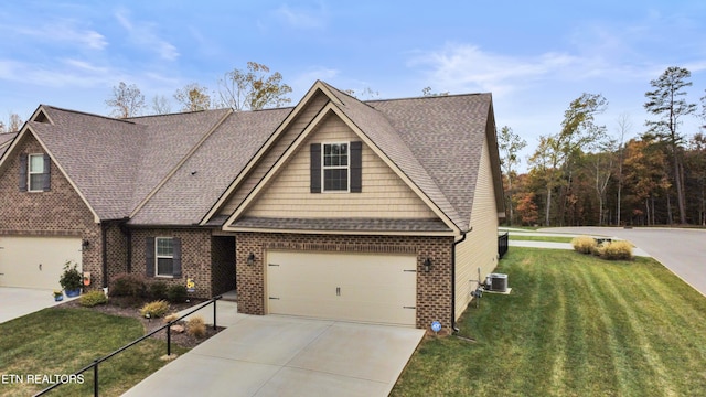 view of front of home featuring a front lawn, a garage, and central AC unit