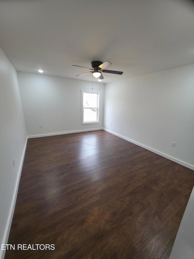 empty room featuring ceiling fan and dark hardwood / wood-style floors