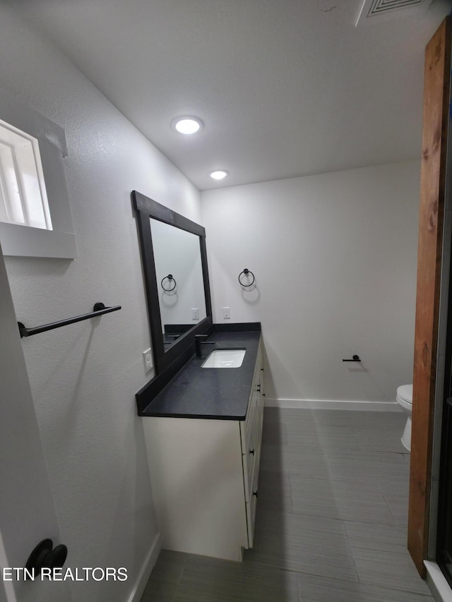 bathroom featuring vanity and toilet