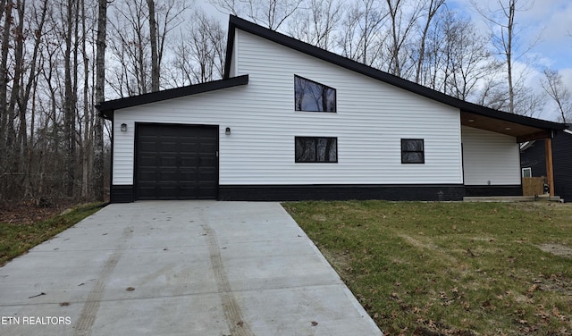 view of property exterior featuring a yard and a garage