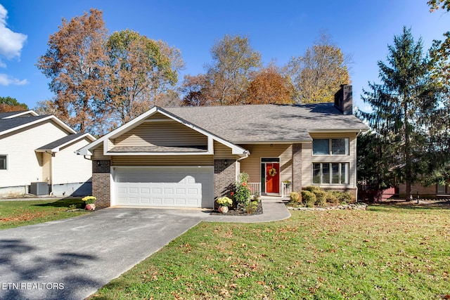 view of front facade with a front yard, a garage, and cooling unit