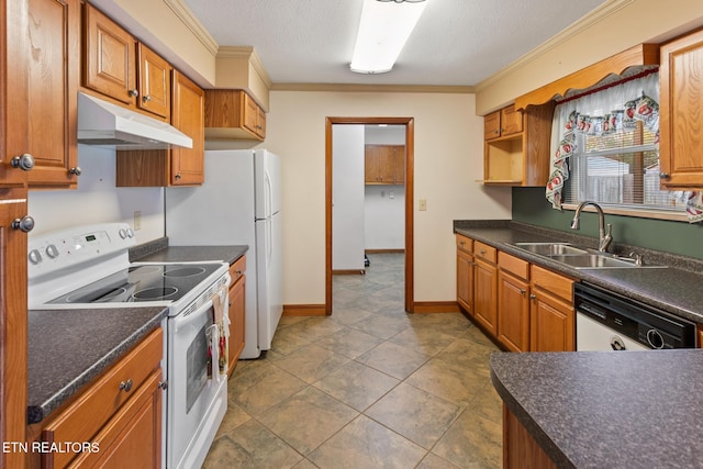 kitchen featuring white appliances, dark tile patterned flooring, crown molding, sink, and a textured ceiling