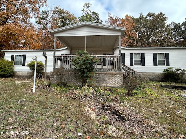 rear view of property with a wooden deck