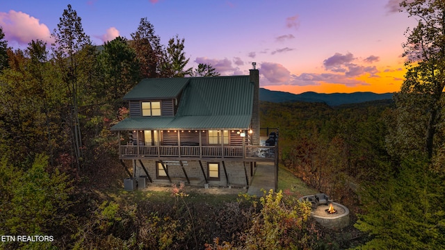 back house at dusk featuring a mountain view