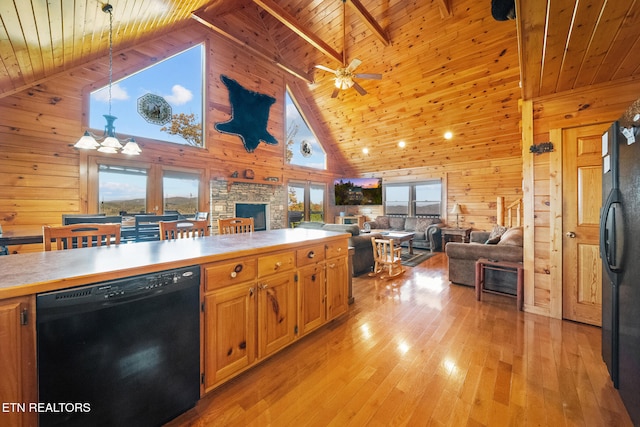 kitchen with light wood-type flooring, high vaulted ceiling, black appliances, and plenty of natural light