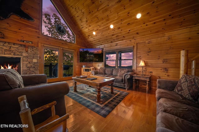 living room with wood ceiling, high vaulted ceiling, wood-type flooring, and plenty of natural light