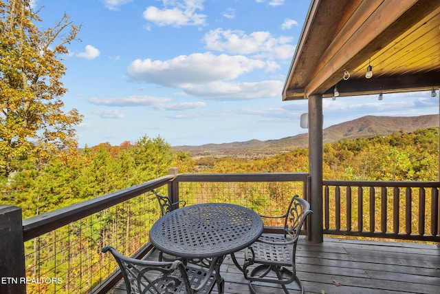 wooden deck with a mountain view