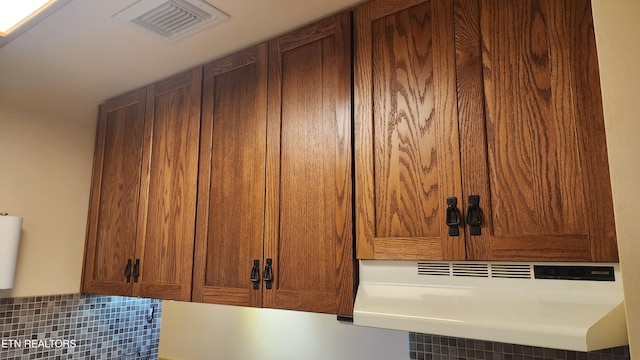 details featuring backsplash and ventilation hood