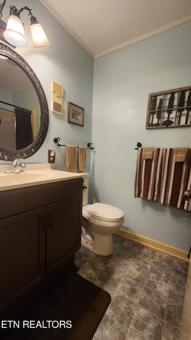 bathroom with toilet, crown molding, and vanity