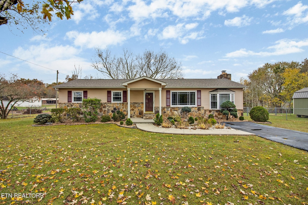 ranch-style house with a front lawn