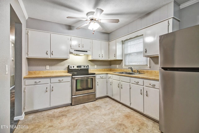 kitchen with appliances with stainless steel finishes, white cabinetry, sink, and a textured ceiling