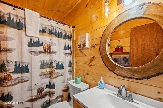 bathroom featuring a shower with shower curtain, wood walls, toilet, and wood ceiling